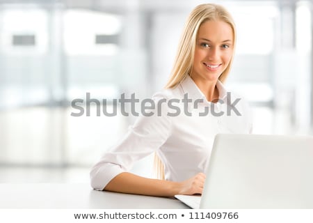 Сток-фото: Charming Blonde Woman Using A Laptop