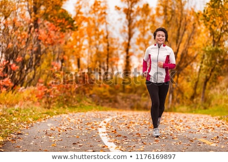 Asian Woman Running In Autumn Forest In Fall Stock foto © Maridav