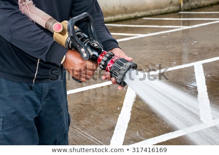 Stock fotó: Firefighter With The Water Cannon