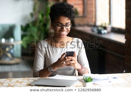 Сток-фото: Smiling African American Woman With Smartphone