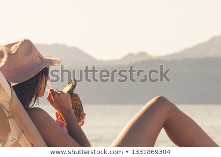 Сток-фото: Sunbathing Beauty Drinks From A Pineapple