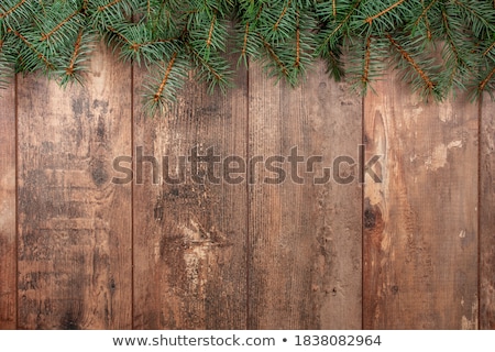 [[stock_photo]]: Christmas Tree Branches On Wooden Texture Ready For Your Design