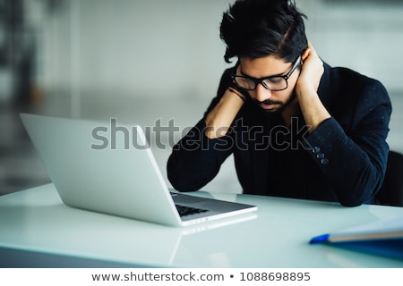 Foto d'archivio: Indian Man Sitting At Office Desk With Computer