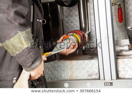 Foto stock: Fire Fighter Connecting Hoses