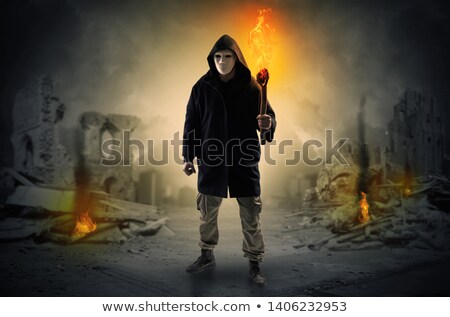 Stock photo: Man Coming With Burning Flambeau At A Catastrophe Scene Concept