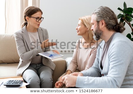 ストックフォト: Young Real Estate Consultant Explaining Her Clients Principles Of Rate Change