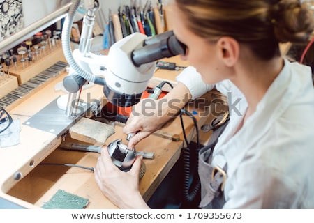 Stock photo: Diligent Jeweler Working On Microscope At Her Workbench