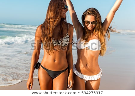 Сток-фото: Young Women In Bikinis On The Beach