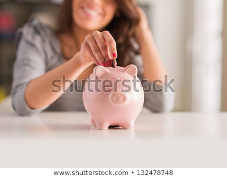 Foto stock: Brunette Woman With Piggy Bank