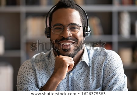 Сток-фото: Young Friendly Receptionist Wearing Headphone