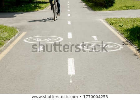 Foto stock: Shadow Of Unrecognizable Cyclist On Bicycle Lane