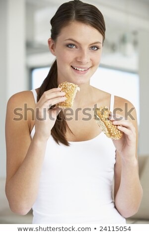 ストックフォト: 色のロールパンを食べる若い女性