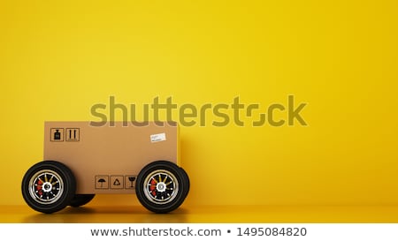 Stok fotoğraf: Cardboard Box On Wheels