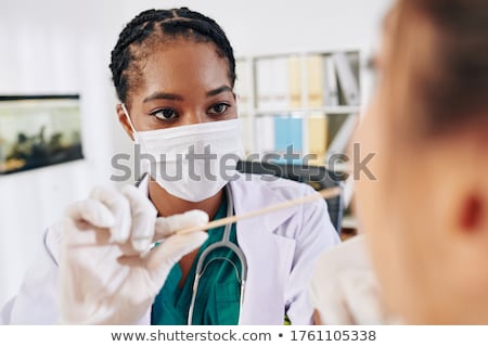 Stock foto: Young Doctor With Stethoscope In Her Doctors Office