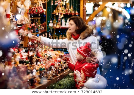 Stockfoto: Family On Christmas Market Buying Ornaments And Baubles