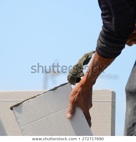 ストックフォト: Mason Pouring Cement Onto Wall