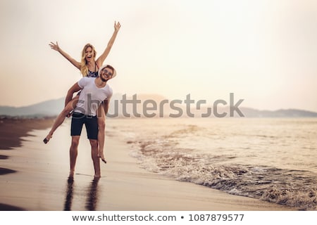 Stock photo: Happy Couple In Love Having Fun On The Beach