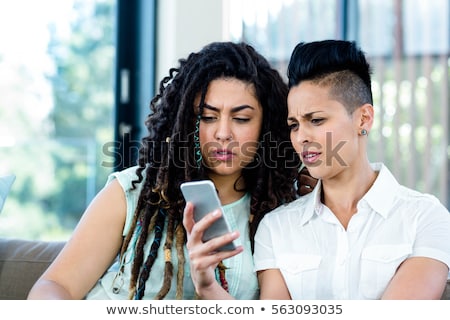 Stock fotó: Close Up Of Lesbian Couple Sitting On Sofa At Home