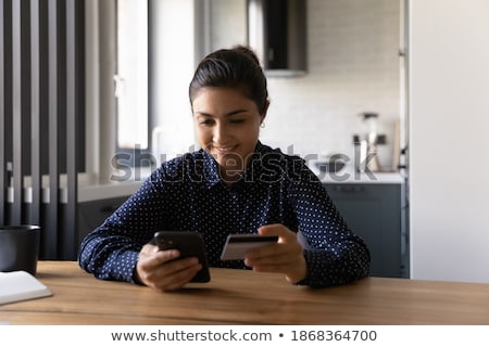 Foto d'archivio: Woman Using Smartphone App To Check E Wallet Account Balance