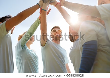 [[stock_photo]]: Group Of Volunteers Making High Five Outdoors