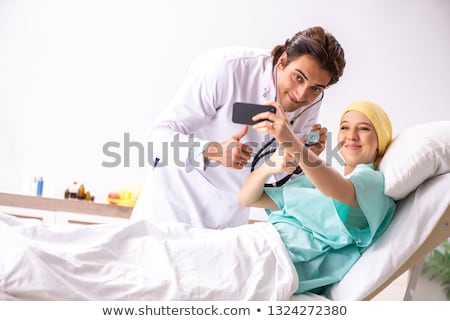 Сток-фото: Young Handsome Doctor Visiting Female Oncology Patient