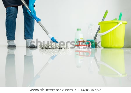 Foto stock: Young Housekeeper Cleaning Floor Mobbing Holding Mop And Plastic