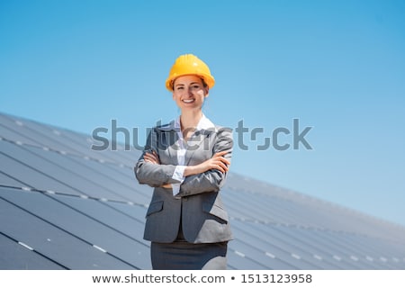 Stock photo: Woman Investor In Clean Energy Standing In Front Of Solar Panels