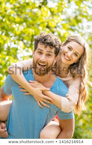 Foto stock: Husband Is Carrying His Wife On His Back Being A Reliable Partner