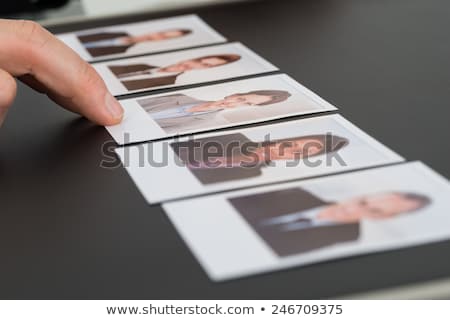 Сток-фото: Businesspeople Choosing Photographs Of Candidates