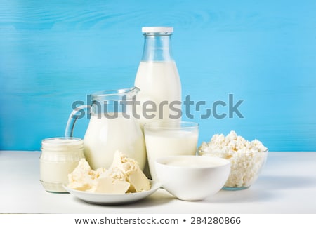 Foto d'archivio: Fresh Dairy Products On White Table Background Glass Jar Of Milk Bowl Of Sour Cream Cottage Chees