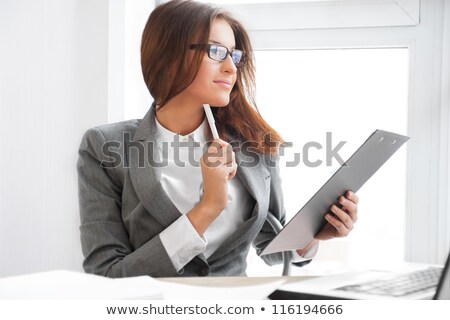 Foto stock: Beautiful Business Woman Smiling While Working With Reports And