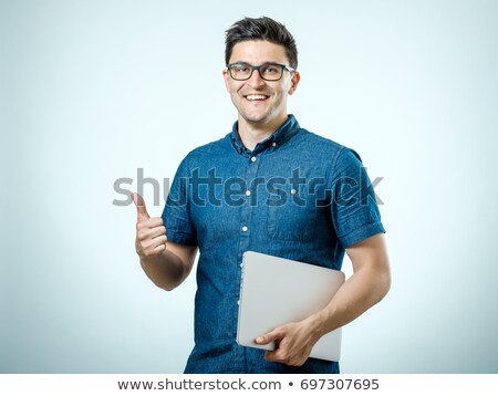 Foto stock: Portrait Of Happy Young Business Man Working Using Laptop Agains