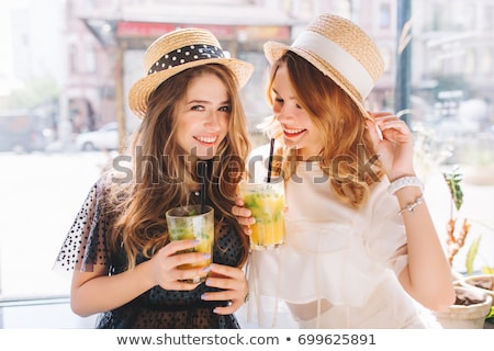 Foto stock: Smiling Young Woman Wearing A Straw Hat And Having Fun At The Be