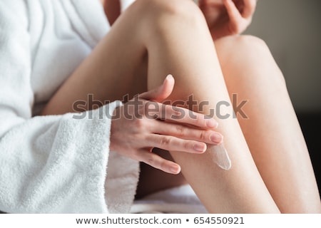 Foto stock: Woman Applying Lotion On Her Hands
