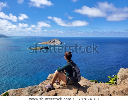 ストックフォト: Woman Sitting On A Mountain With Binocular