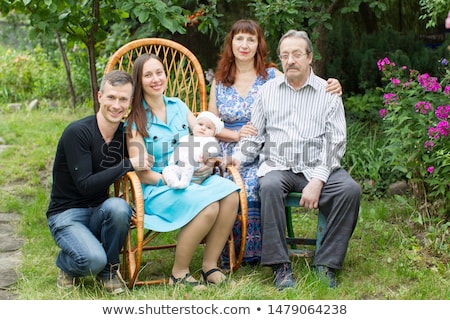 Stock foto: Extended Family Group Posing In The Garden With Grandparents