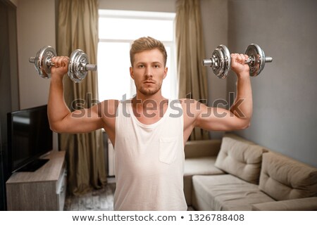 Stok fotoğraf: Using Dumbbells At Home