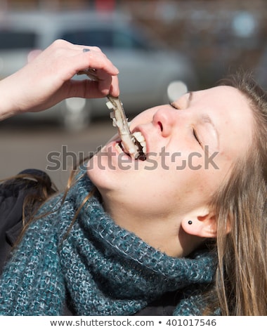 Stock photo: Dutch Woman Is Eating Typical Raw Herring