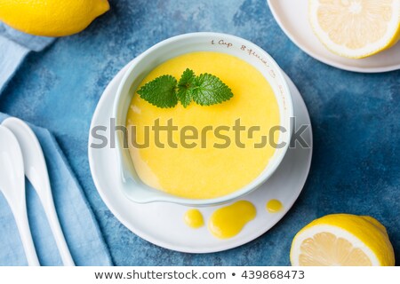 Foto stock: Lemon Curd In Ceramic Bowl With Fresh Lemons On A Blue Napkin Background Top View Selective Focus