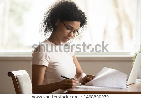 Foto stock: Female Freelancer Doing Paperwork