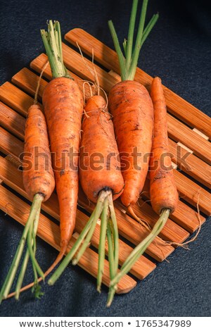 ストックフォト: Fresh Carrots Lying On Black Soil