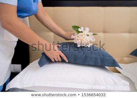 A Man Putting A Rose On A Pillow Stockfoto © Pressmaster