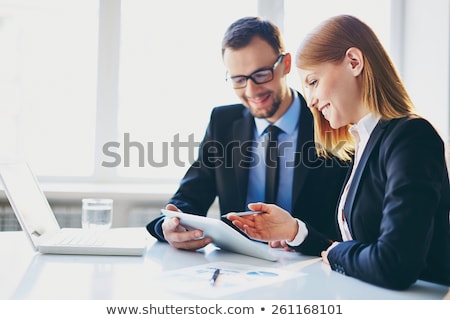 Businesswoman Showing Digital Tablet To Colleague Stockfoto © Pressmaster