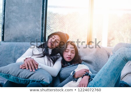 Stok fotoğraf: Happy Asian Teenage Girl Sleeping On Sofa At Home