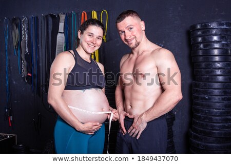 Zdjęcia stock: Husband Measuring His Pregnant Wifes Belly With Tape