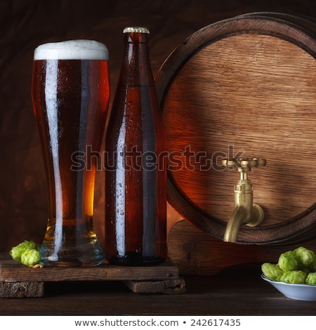 Stok fotoğraf: Cold Glass Of Craft Beer On Old Wooden Barrel