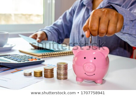 Foto d'archivio: Businessman Calculating Invoice With Piggy Bank