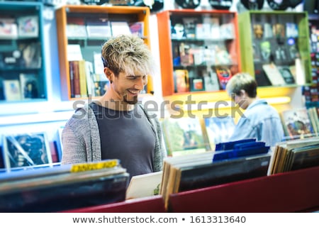 Stockfoto: Young Man Choosing Vintage Vinyl Lp In Records Shop