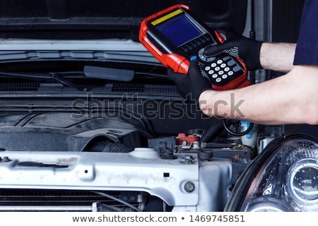 Foto stock: Mechanic Man With Diagnostic Scanner At Car Shop