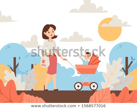 Stockfoto: Mother Walking With A Baby Pram In The Park